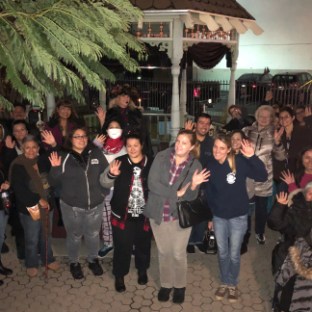 a group of people standing in front of a crowd posing for the camera