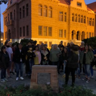a group of people walking on a city street