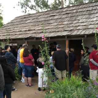 a group of people standing in front of a house