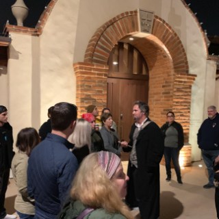 a group of people standing in front of a building
