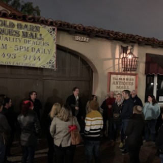 a group of people walking in front of a crowd