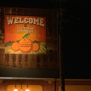 a sign lit up at night