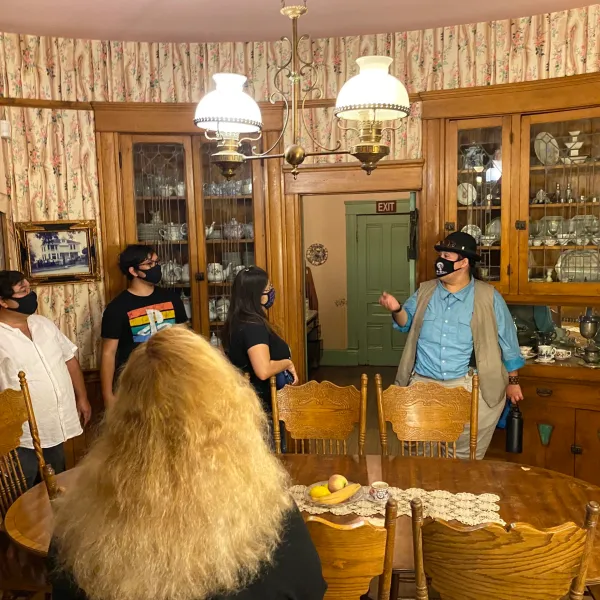 a group of people standing around a table