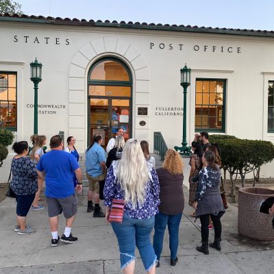 a group of people standing in front of a building