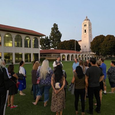 a group of people standing in front of a building
