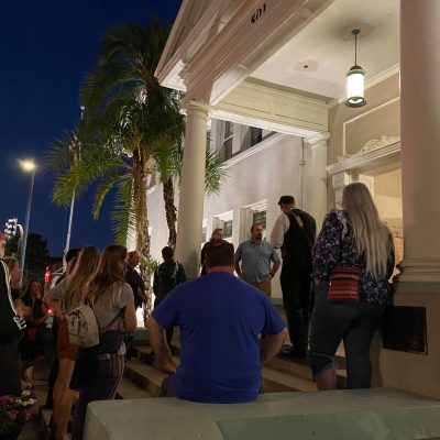 a group of people standing in front of a building