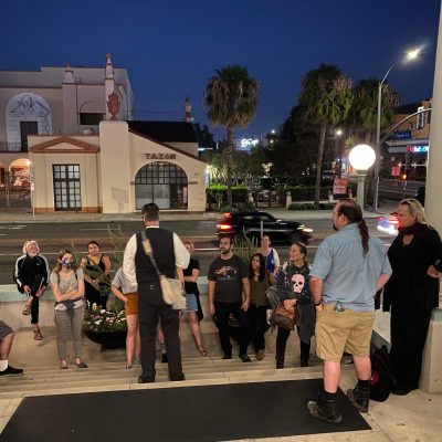 a group of people walking on a sidewalk