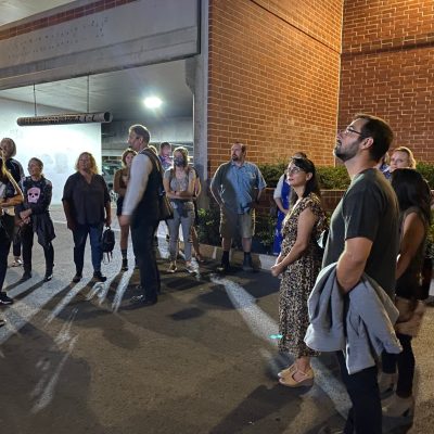 a group of people standing in front of a building