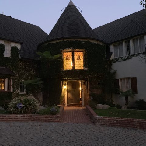 a small clock tower in front of a house