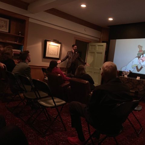 a group of people sitting around a living room