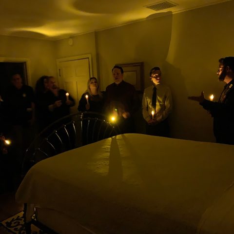 a group of people sitting on a bed