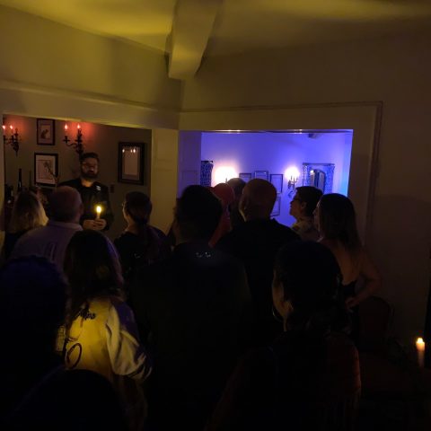 a group of people standing in a dark room