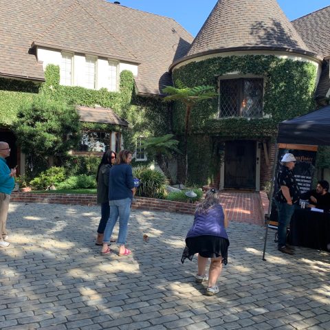 a group of people standing outside of a building