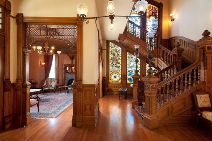 a living room filled with furniture on top of a hard wood floor