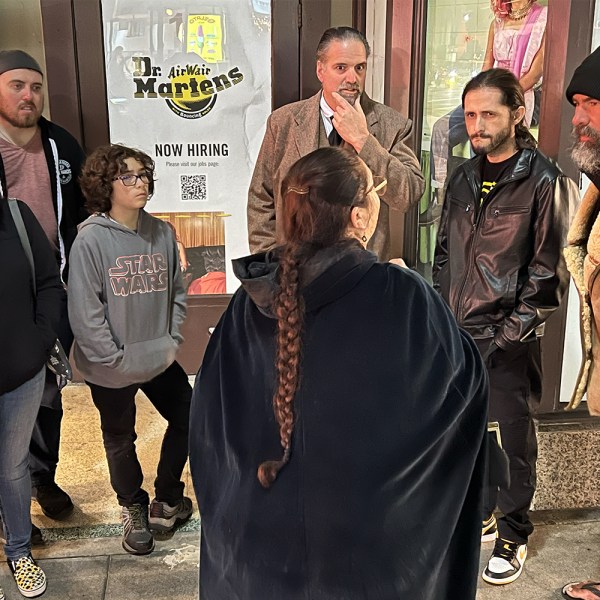 a group of people standing in front of a crowd posing for the camera