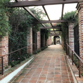 a gate in front of a brick building