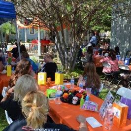 a group of people sitting at a picnic table