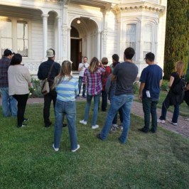 a group of people that are standing in the grass