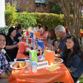 a group of people sitting at a picnic table