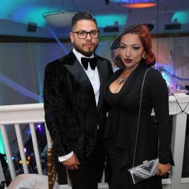 a man wearing a suit and tie standing in a room