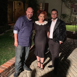 a man and a woman standing in front of a building