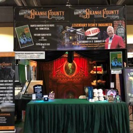 a group of people sitting at a desk in front of a store