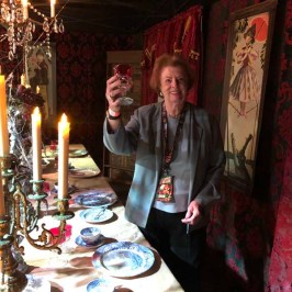 Patricia Kennedy Lawford standing in front of a birthday cake with lit candles