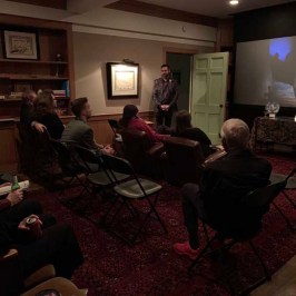 a group of people sitting around a living room
