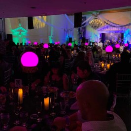 a group of people sitting on a stage in front of a crowd