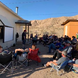 a group of people sitting in front of a building