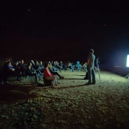 a group of people walking in the dark