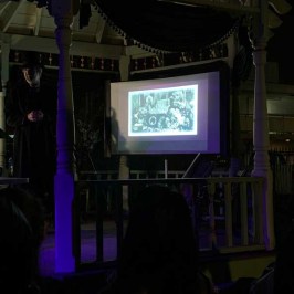 a group of people watching television in a dark room