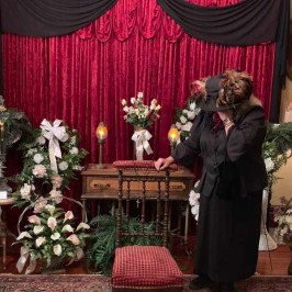 a person standing in front of a curtain