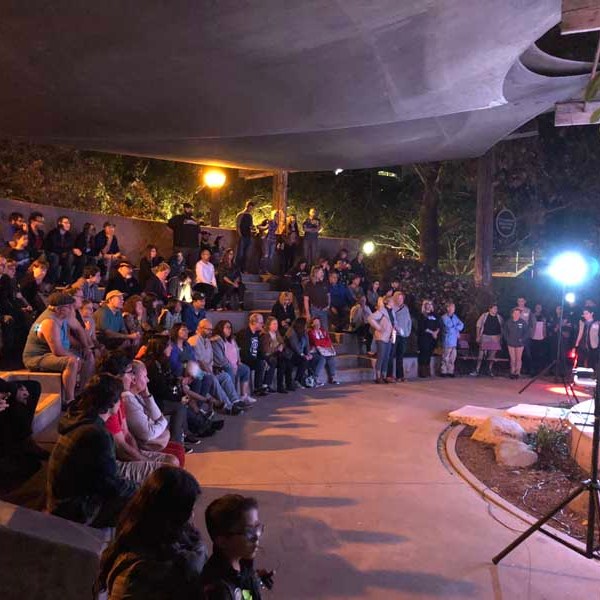 a group of people performing on stage in front of a crowd