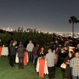 a group of people standing in front of a crowd posing for the camera