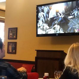 a person standing in front of a television