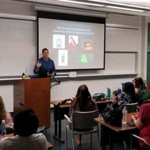 a group of people sitting in front of a computer