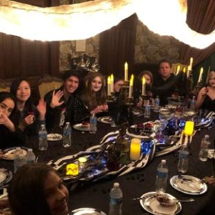 a group of people sitting at a table with wine glasses
