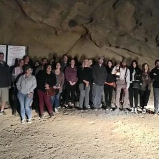a group of people standing in the dirt