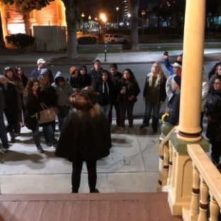 a group of people standing in front of a building