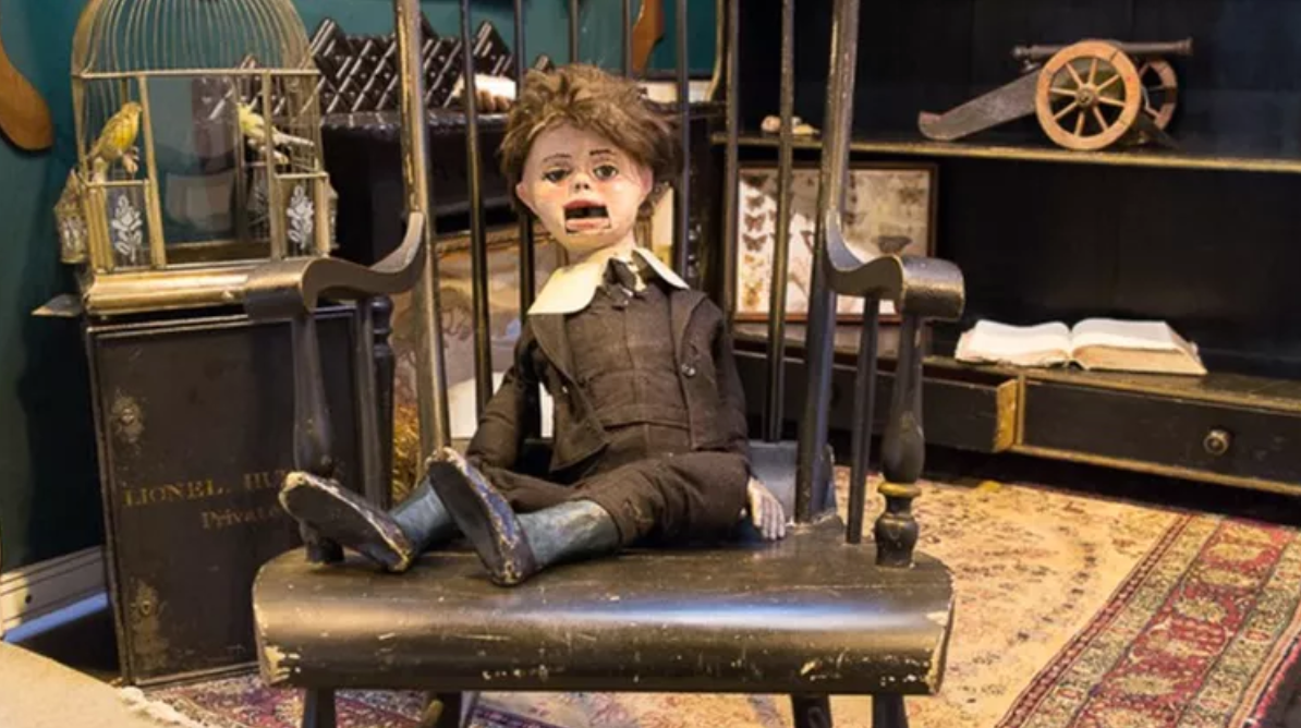 a doll sitting on a chair