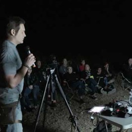 a group of people playing instruments and performing on a stage