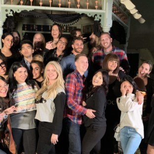 a group of people standing in front of a crowd posing for the camera