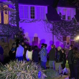 a group of people standing on a stage in front of a crowd