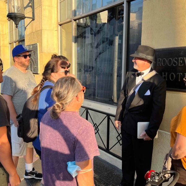 a group of people standing on a sidewalk