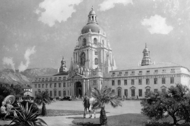 a vintage photo of a horse drawn carriage in front of a building