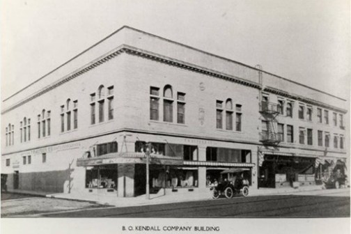 a vintage photo of a bus on the side of a building